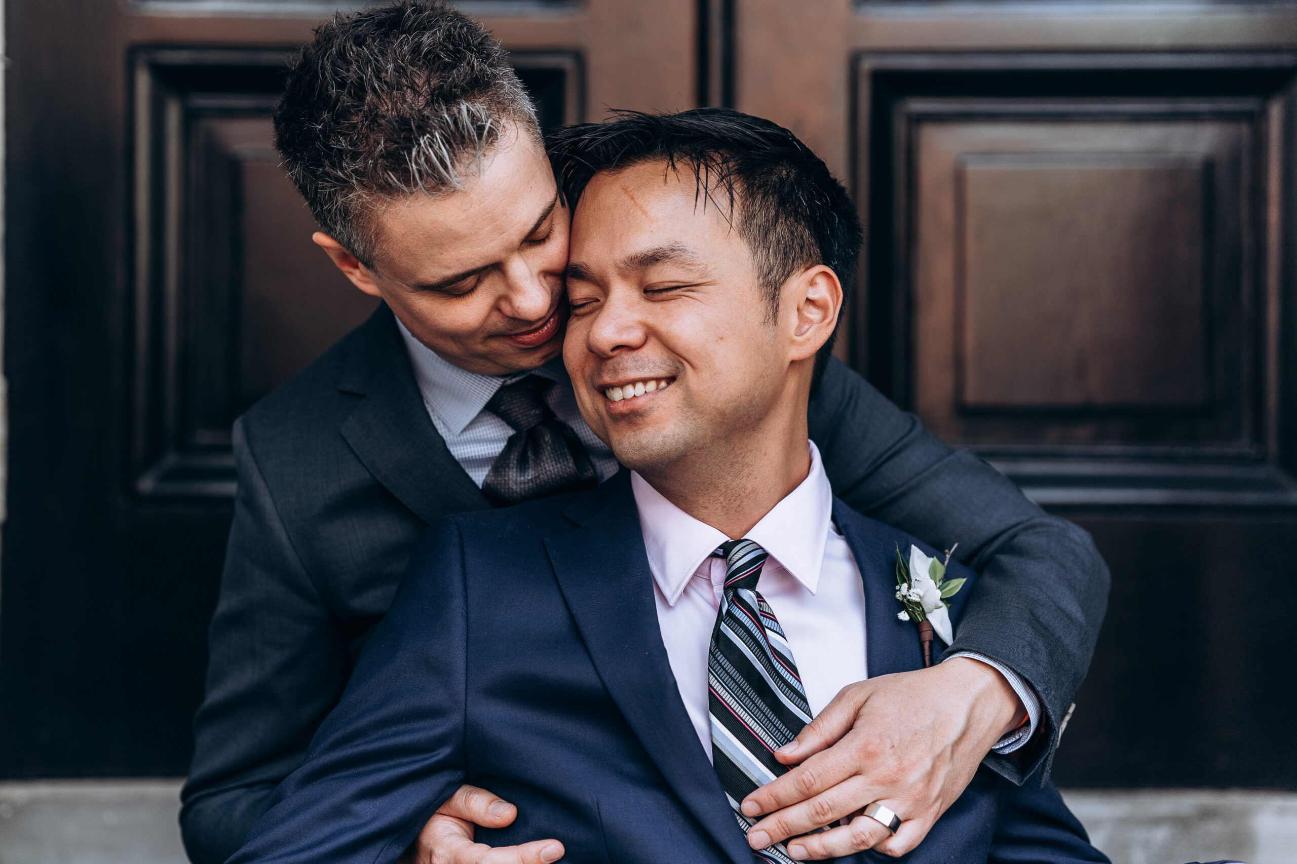 groom and groom in embrace toronto Windsor arms hotel