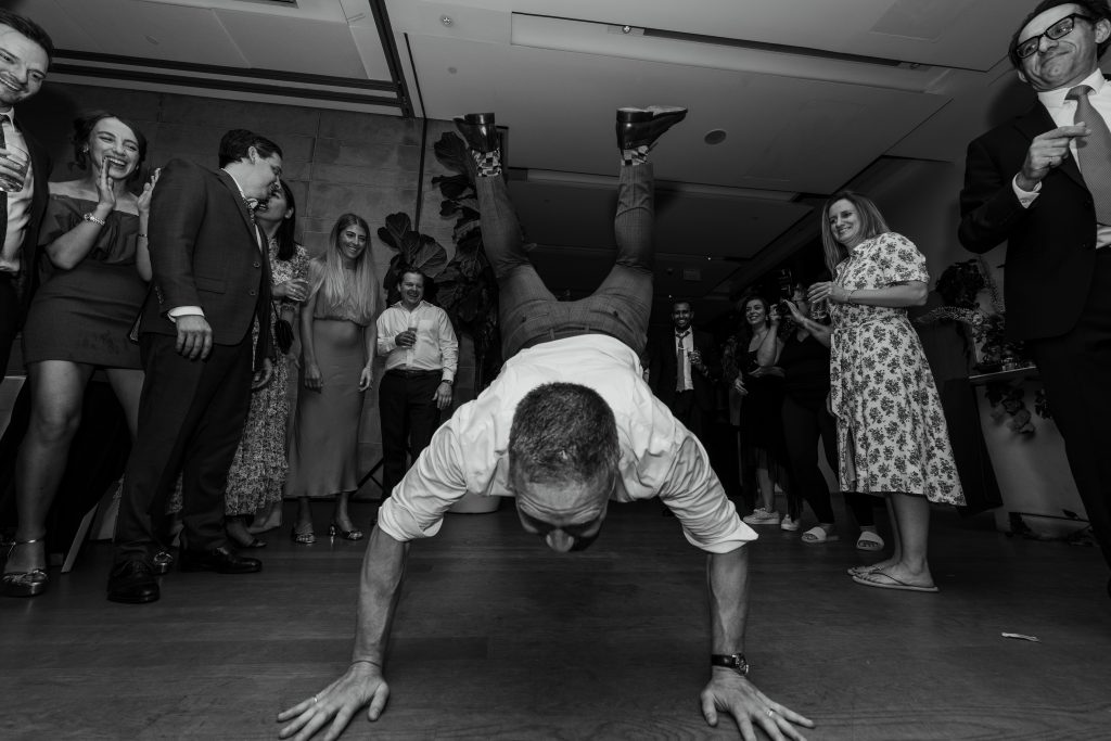 toronto wedding photographer captures image of guest doing the worm on the dance floor at the Gardiner museum