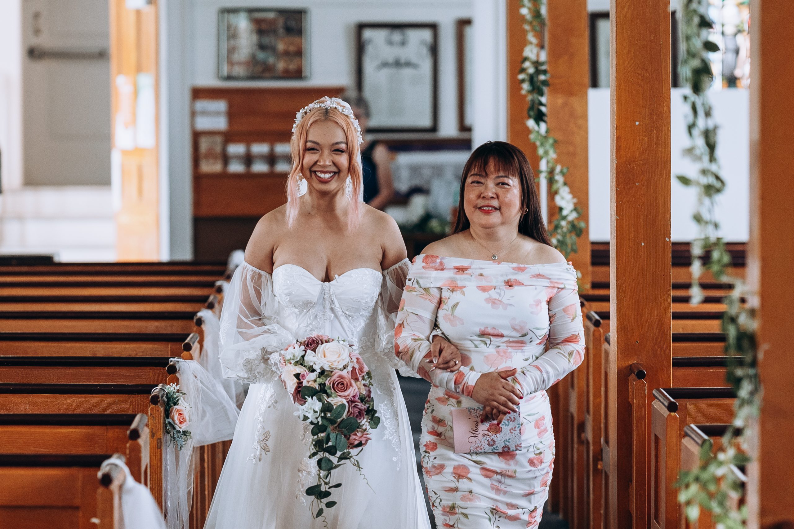 mom walks her daughter the bride down the aisle