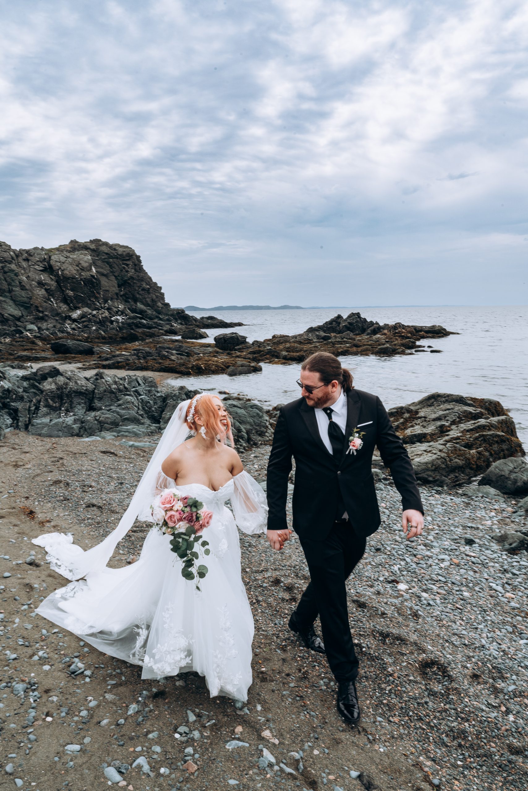bride and groom walking hand in hand in Twillingate newfoundland