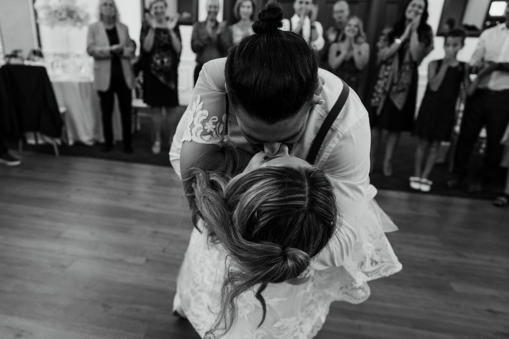 groom dips the bride at their wedding reception in toronto