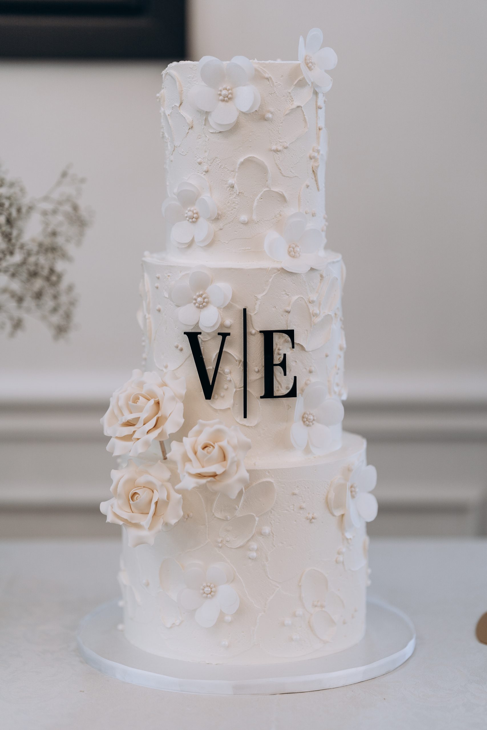 detail image of a wedding cake with the bride and grooms initials on it