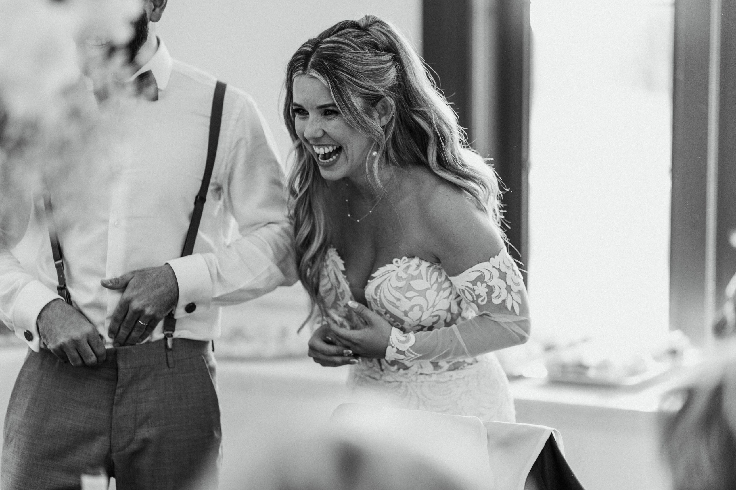 bride shares a laugh during her wedding reception