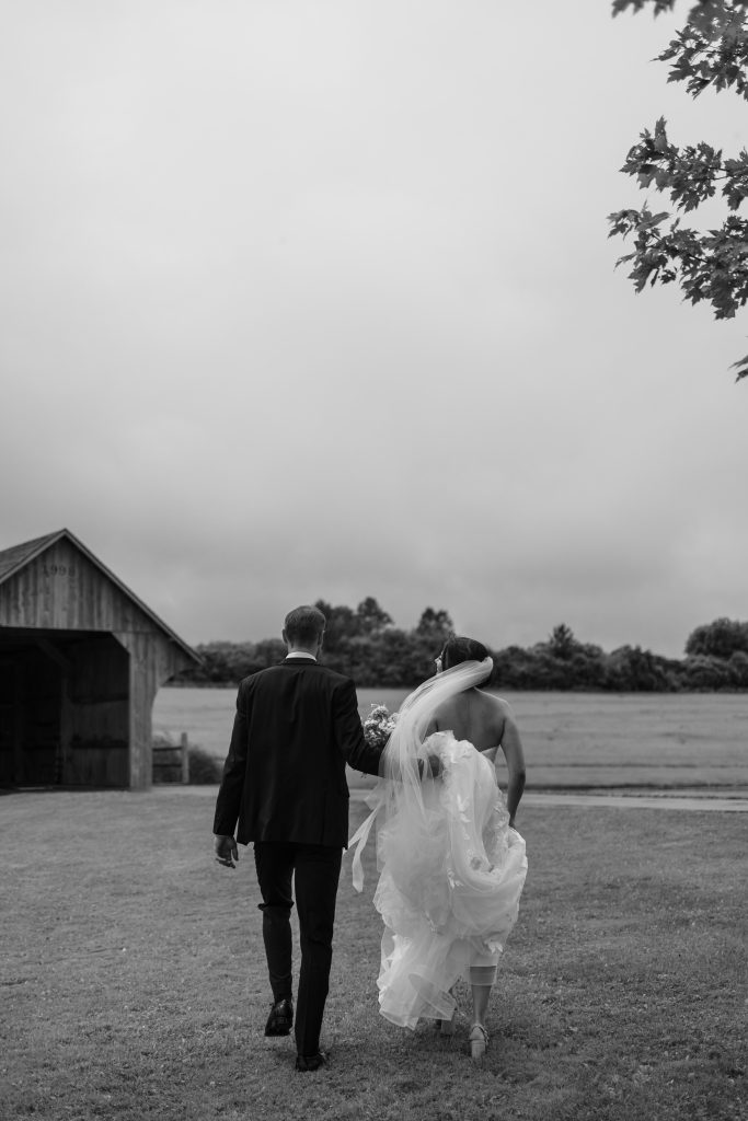 bride and groom walk hand in hand after their wedding ceremony at the vue event space in toronto
