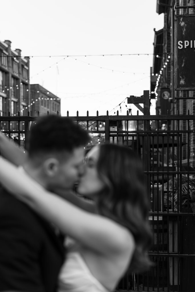 bride and groom embrace at the distillery district in toronto during their wedding reception