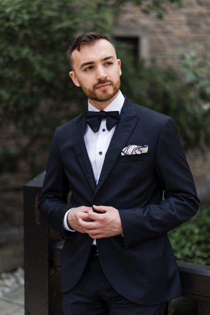 groom poses for a portrait at the old mill hotel in toronto