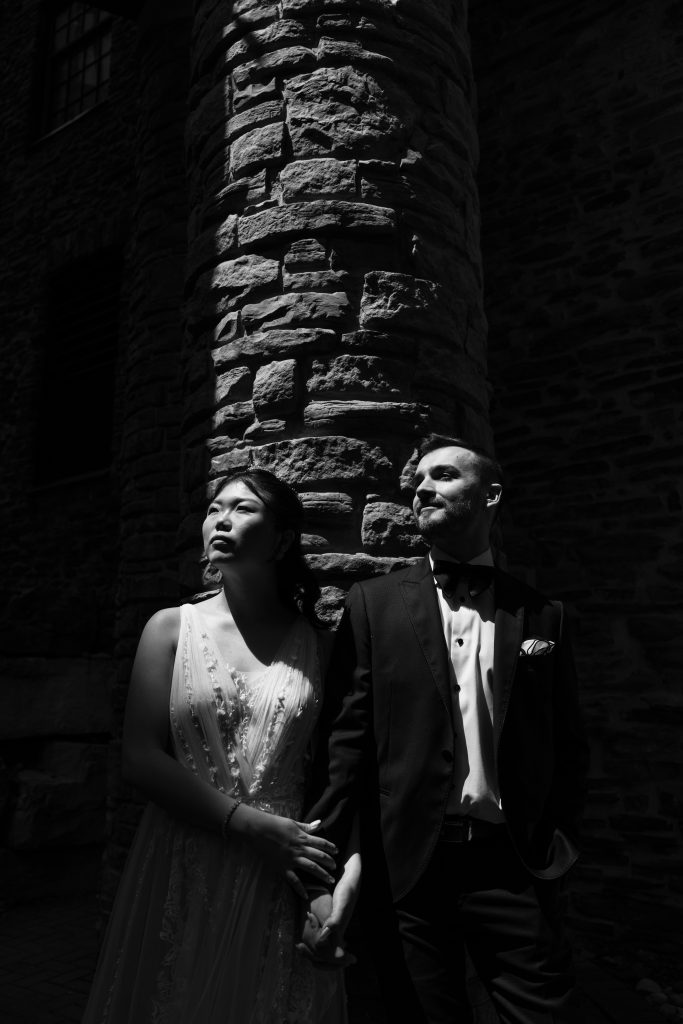 bride and groom pose for a photo hand in hand at the old mill in toronto